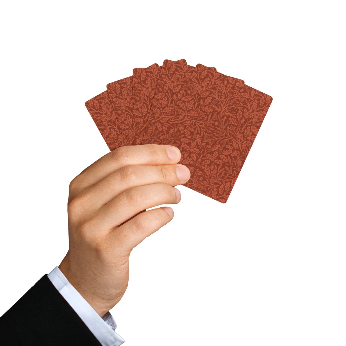 Hand holding a stack of red playing cards against a white background