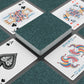 Playing cards with decorative designs on a dark surface