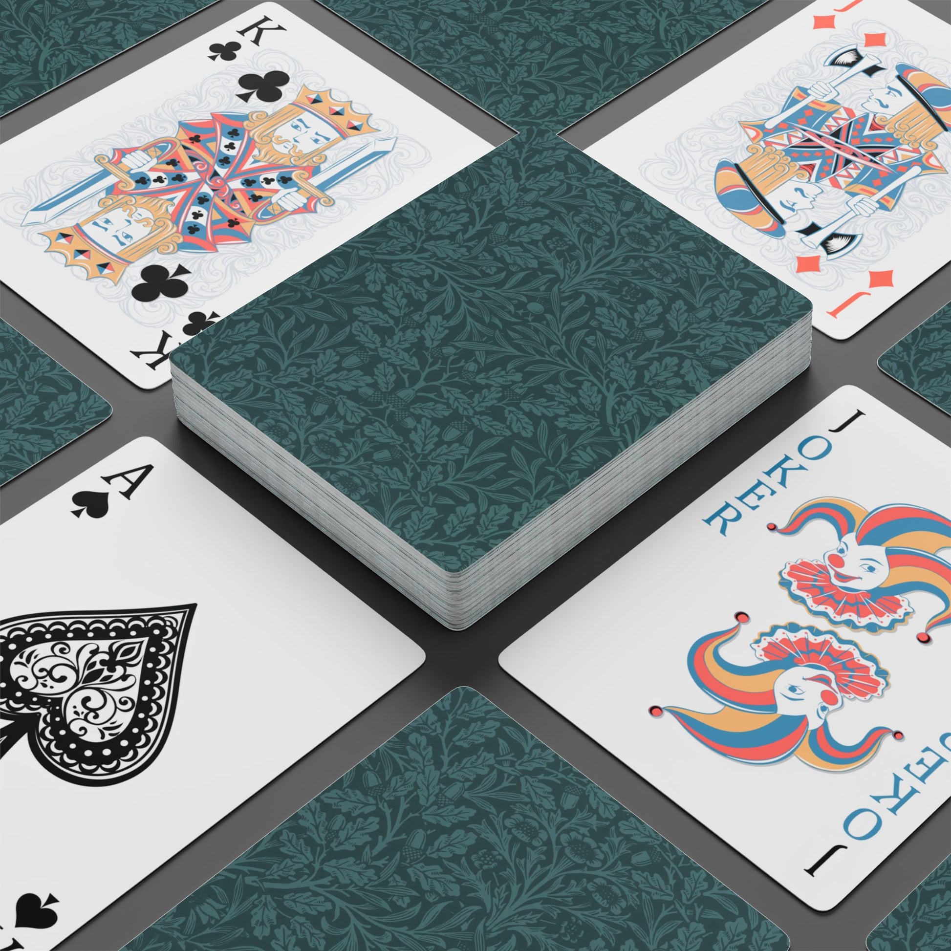 Playing cards with decorative designs on a dark surface