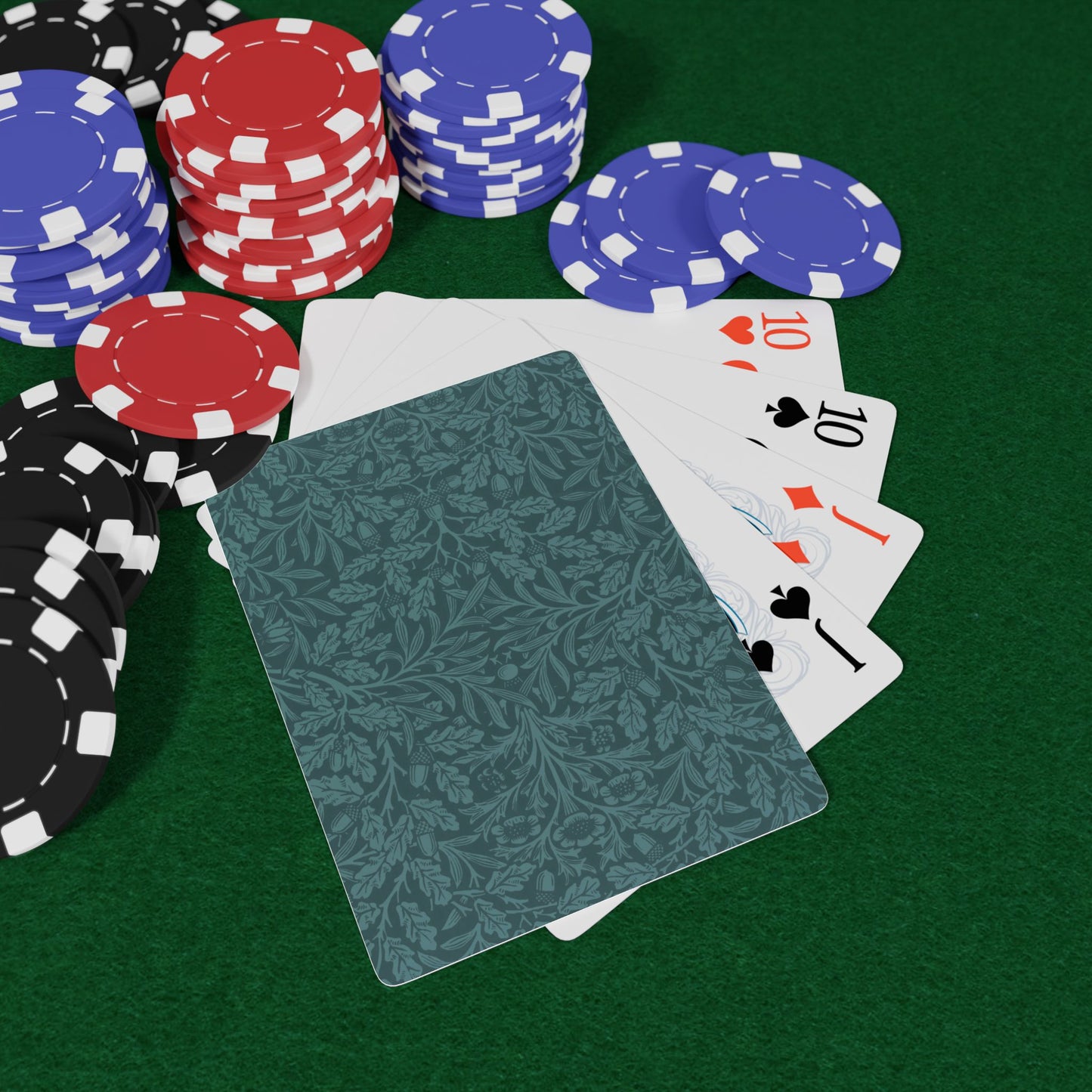 Poker chips and cards on a green felt surface