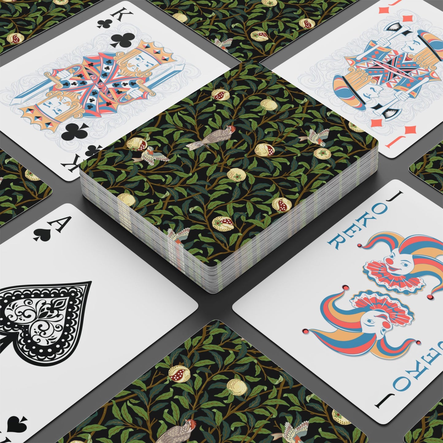 Playing cards with decorative designs on a black surface