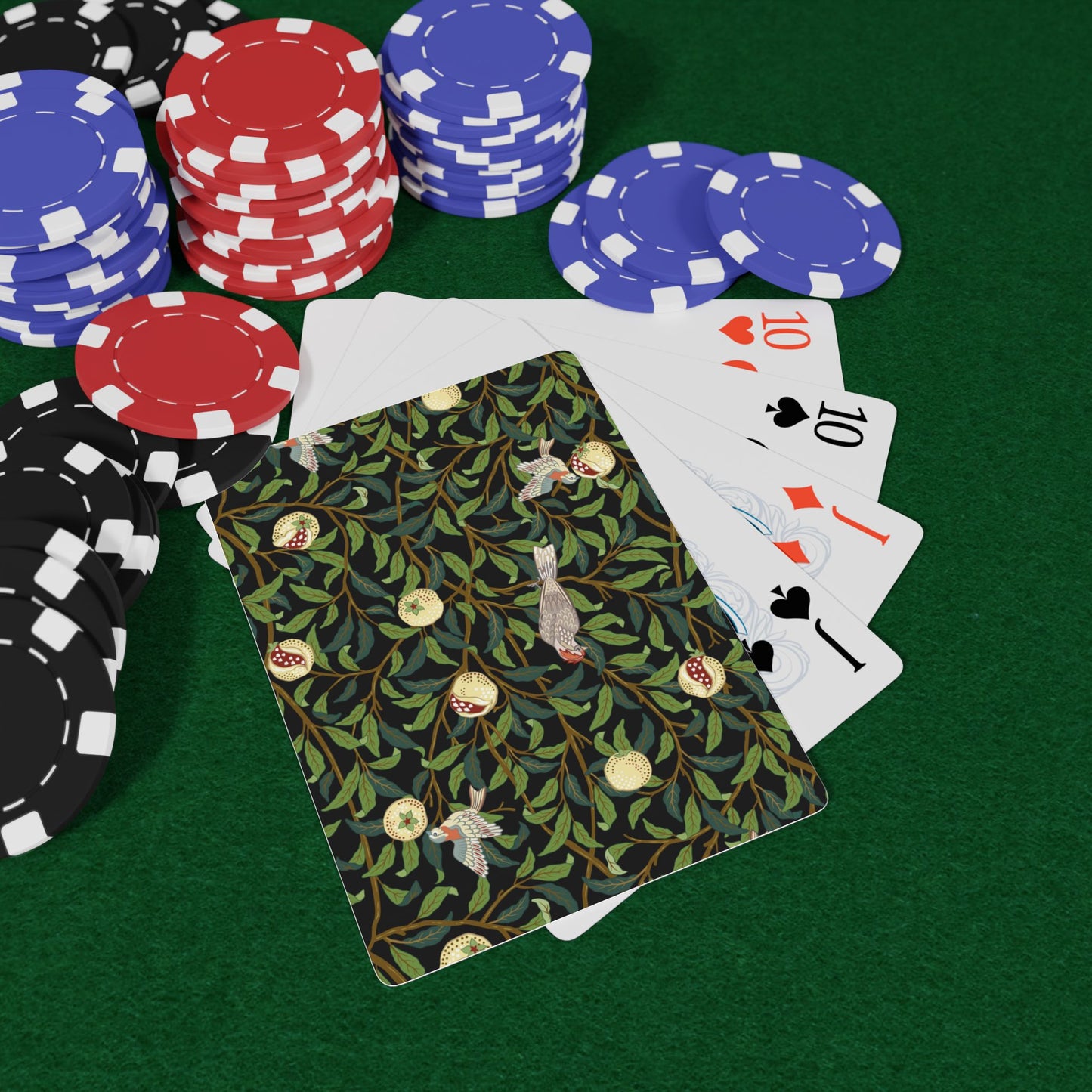 Poker chips and playing cards on a green surface