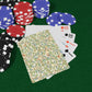 Poker chips and playing cards on a green surface