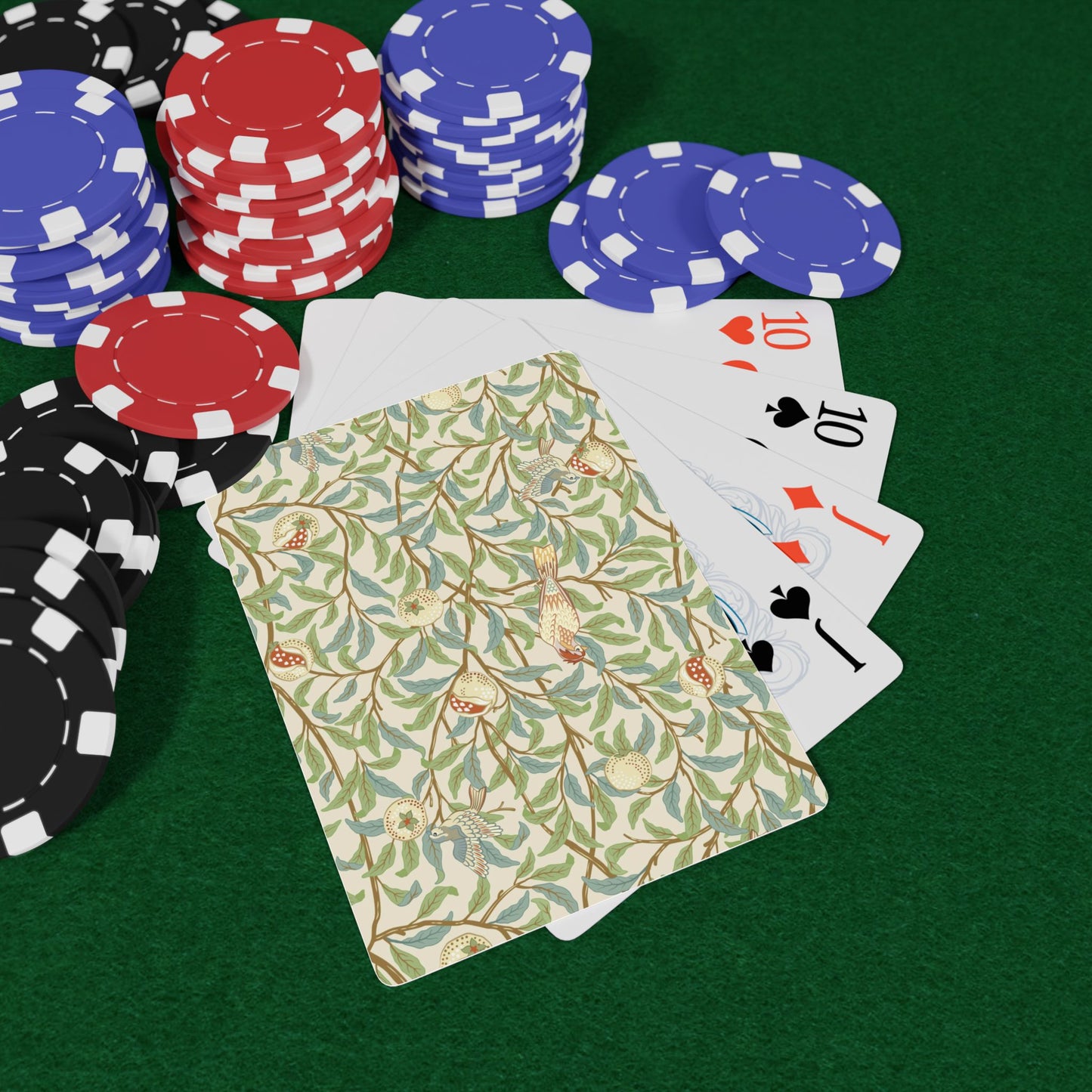 Poker chips and playing cards on a green surface