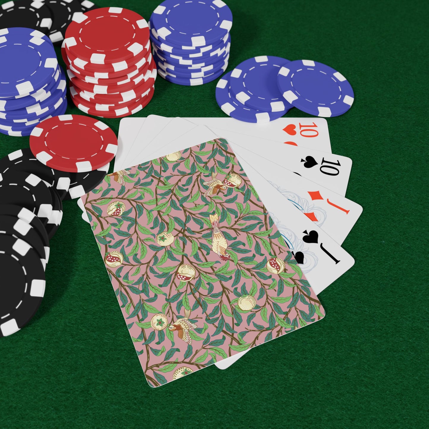 Poker chips and playing cards on a green felt surface