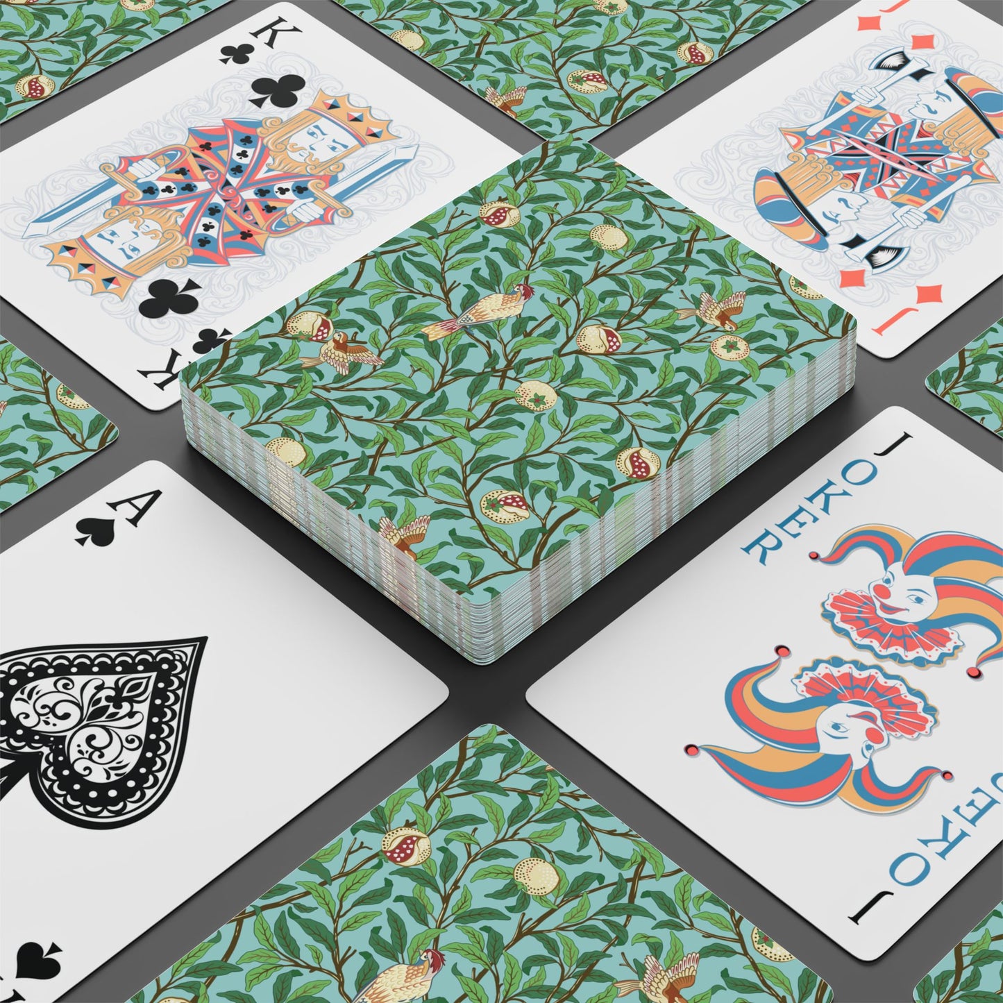Playing cards with floral and colorful designs on a black surface