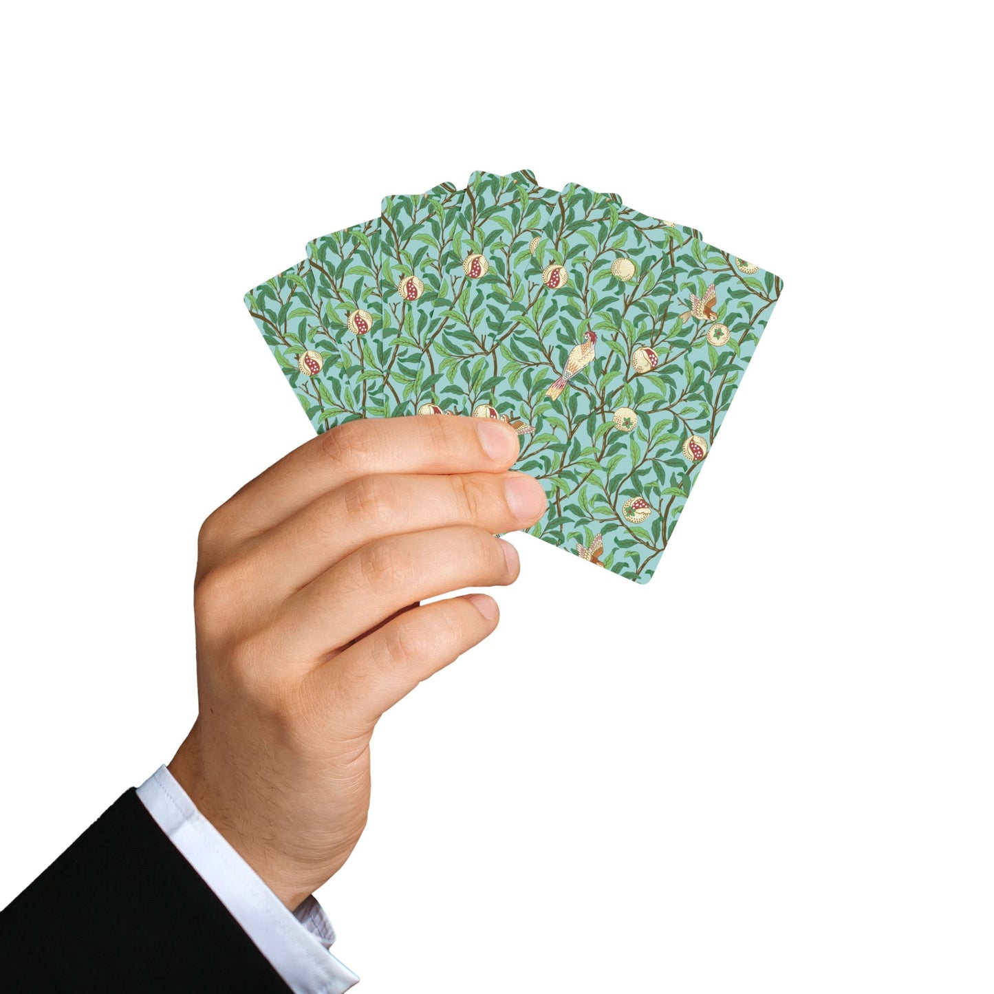 Hand holding a deck of playing cards with a floral design on a white background