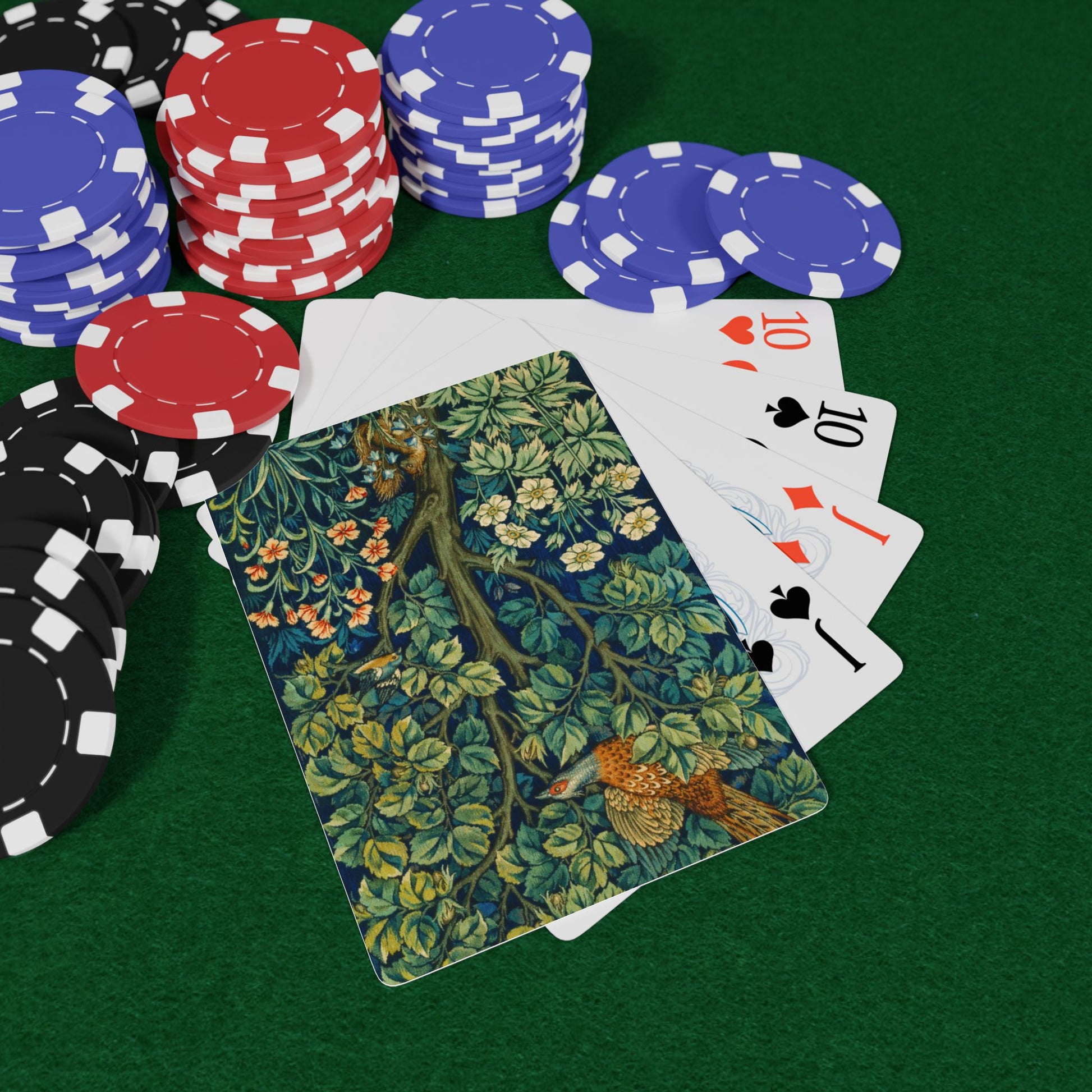 Poker chips, playing cards, and a nature-themed card on a green surface