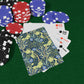 Playing cards with floral design and poker chips on a green surface