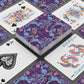 Playing cards with decorative purple and blue designs on a gray surface