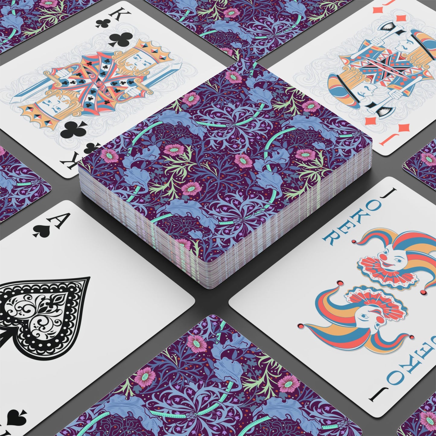 Playing cards with decorative purple and blue designs on a gray surface
