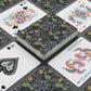Playing cards with decorative designs on a gray surface