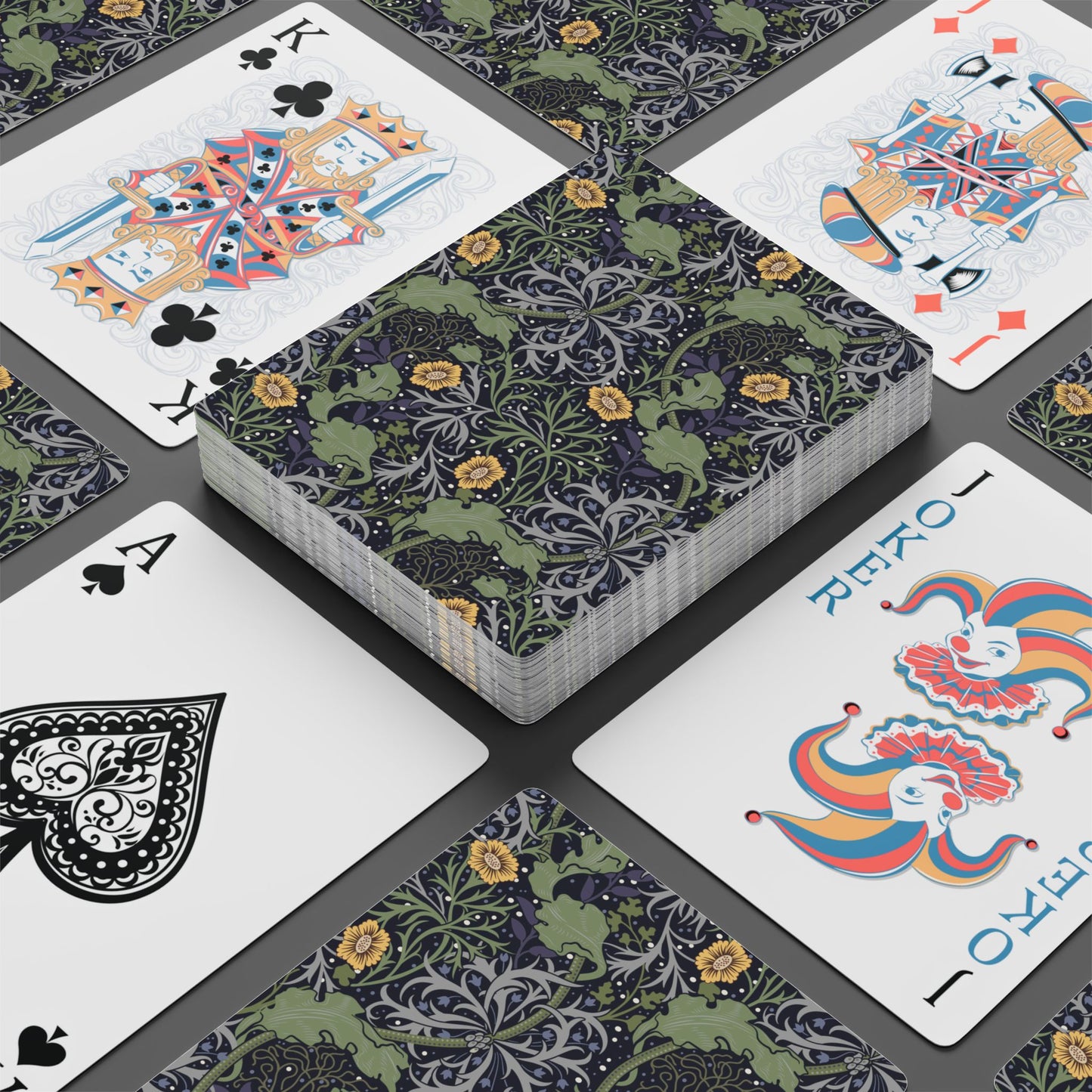 Playing cards with decorative designs on a gray surface