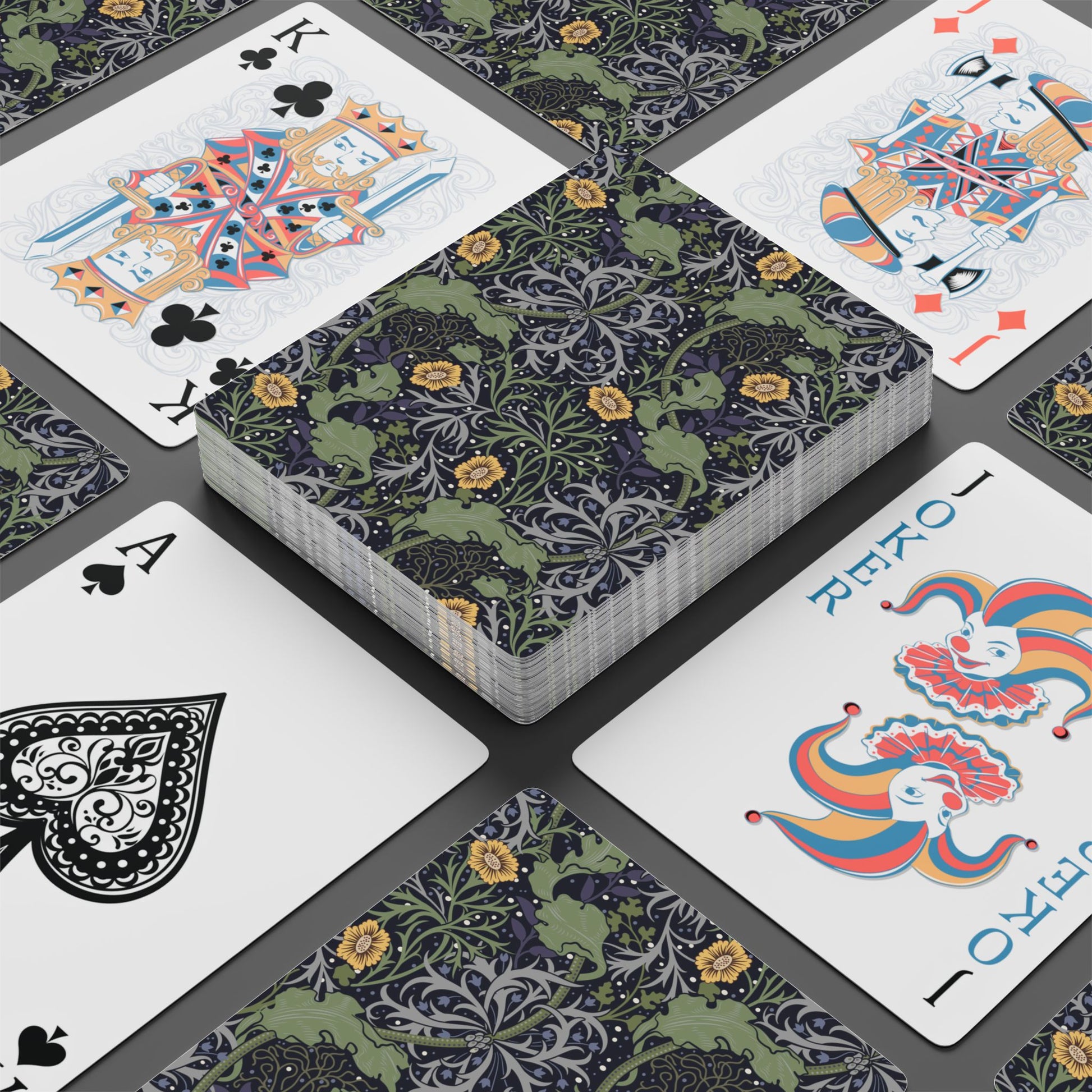 Playing cards with decorative designs on a gray surface