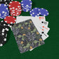 Poker chips and playing cards on a green felt surface