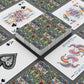 Playing cards with decorative designs on a gray surface