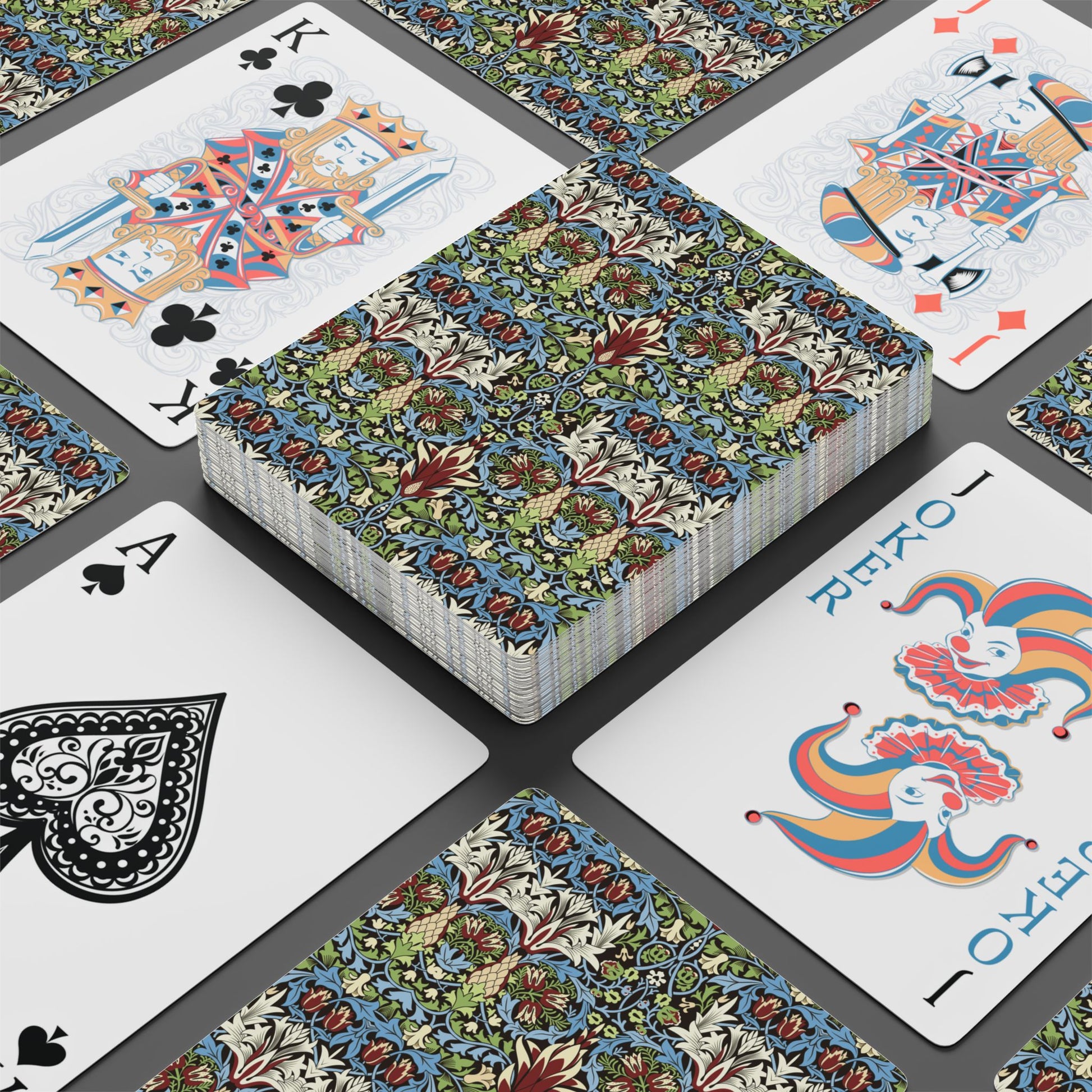 Playing cards with decorative designs on a gray surface