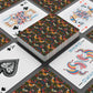 Playing cards with floral and animal pattern on a gray surface