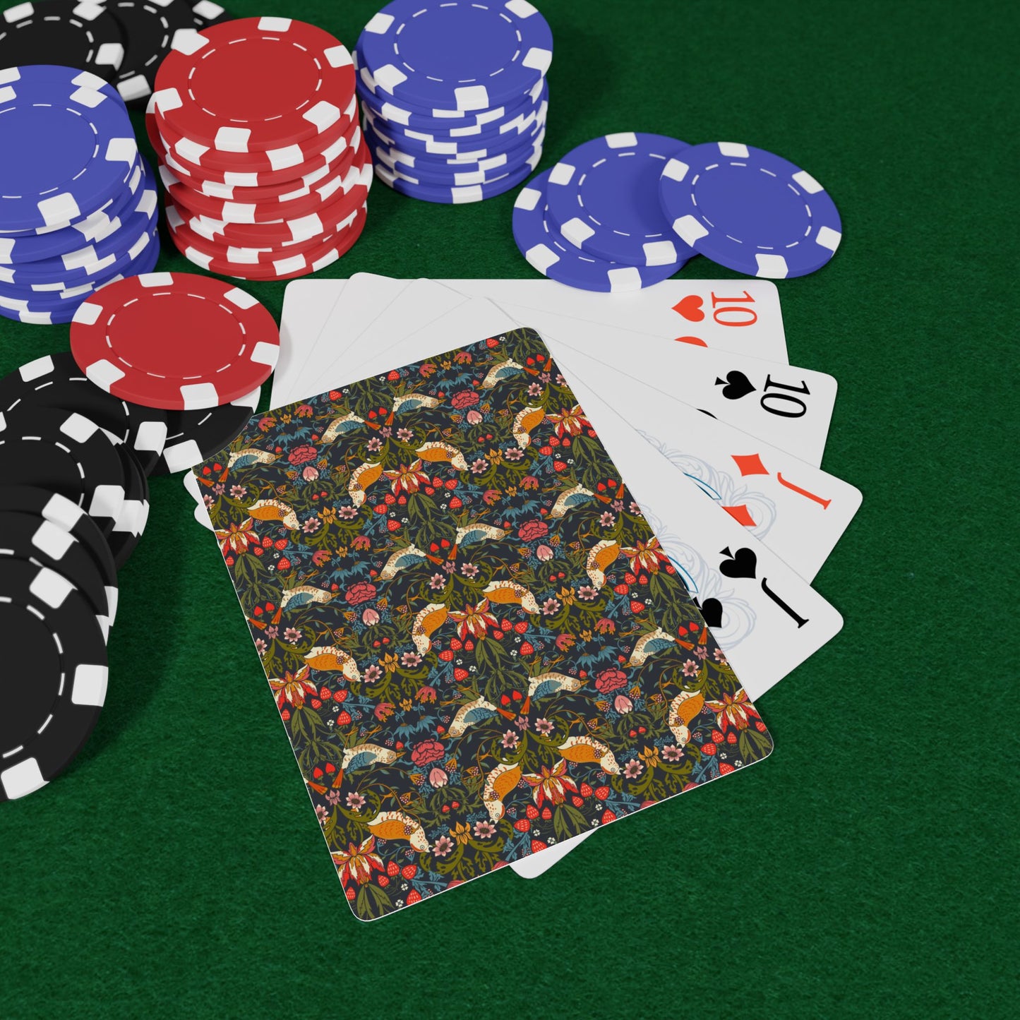 Poker chips and playing cards on a green felt surface