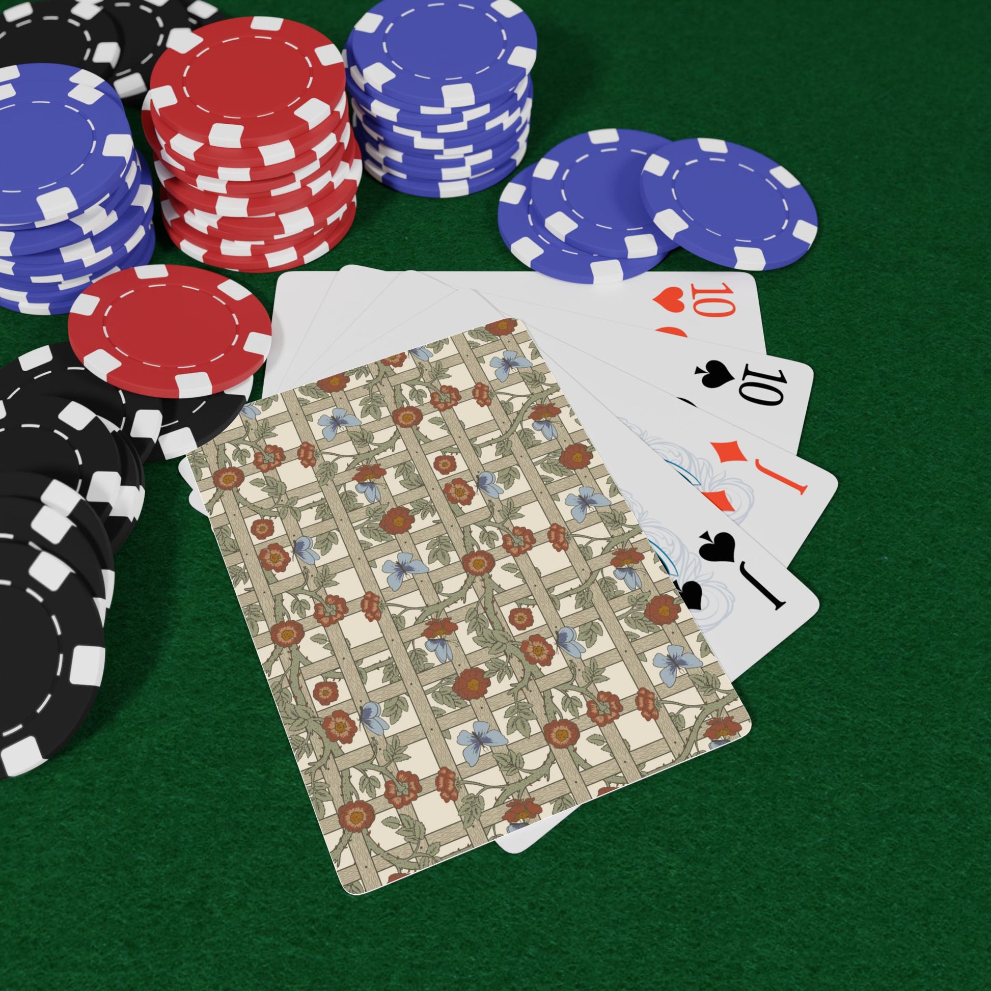 Poker chips and playing cards on a green felt surface