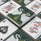 Playing cards with decorative designs on a black surface