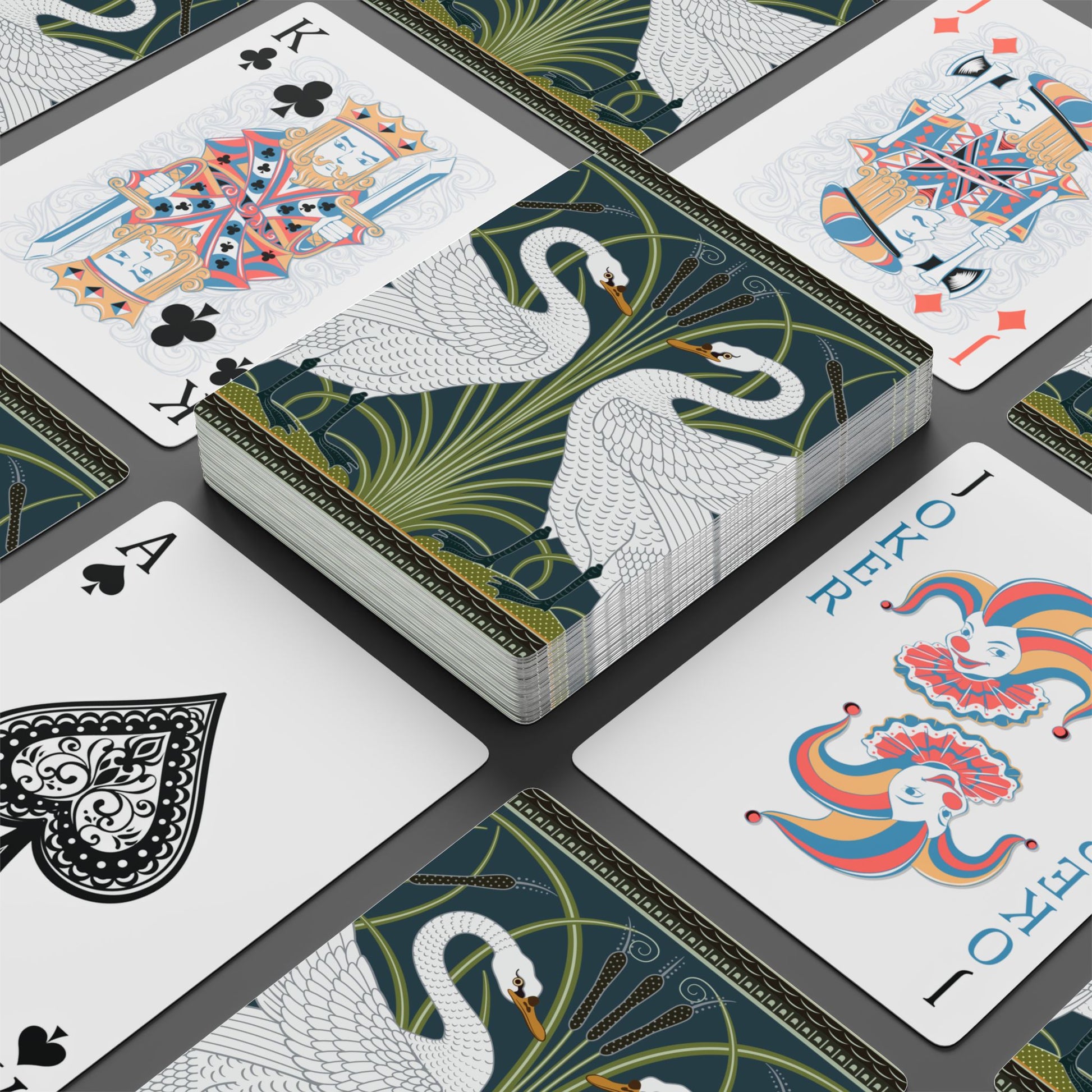 Playing cards with decorative designs on a black surface