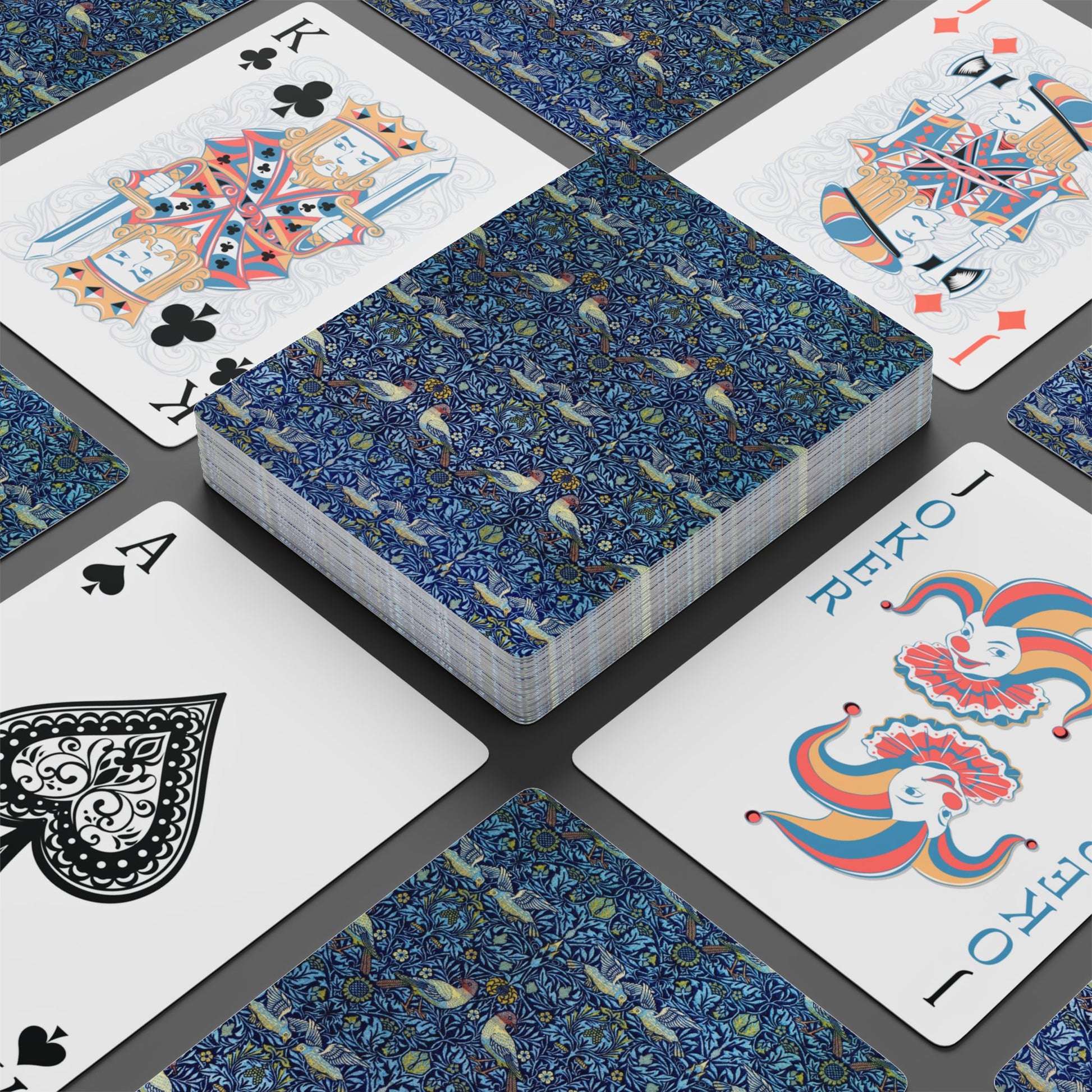 Playing cards with decorative designs on a black surface