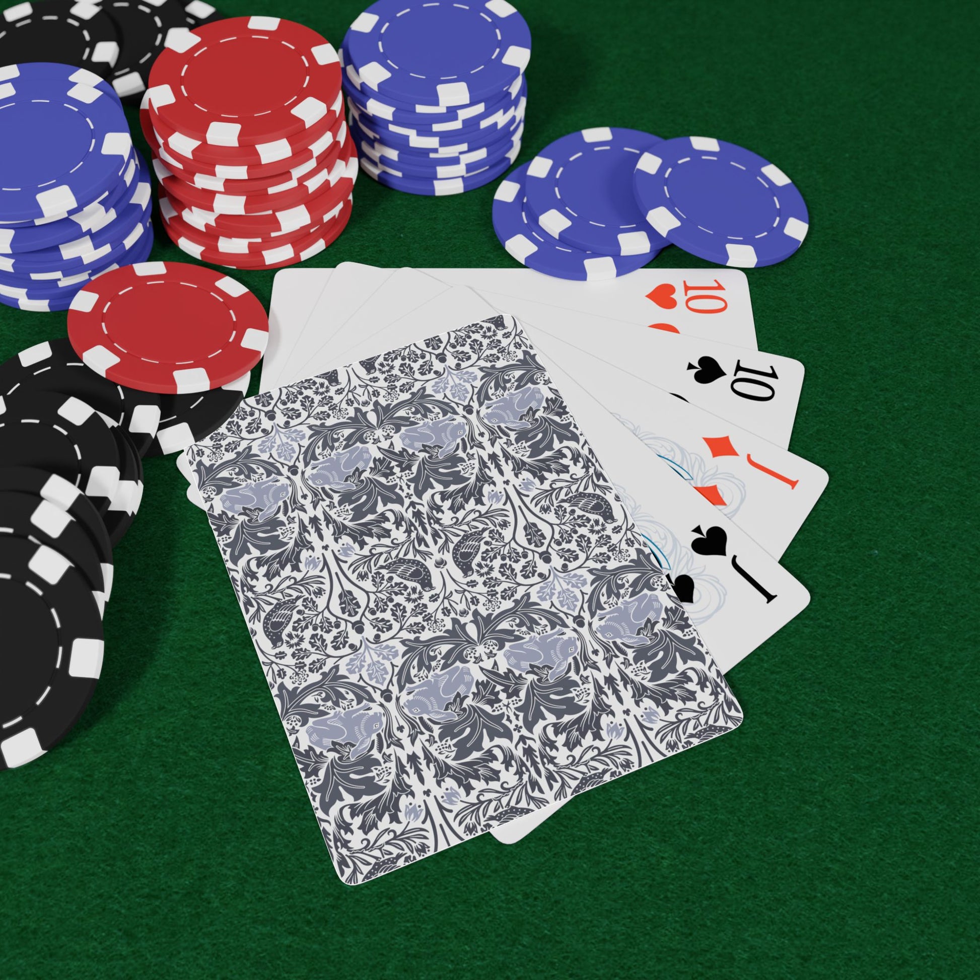 Poker chips and playing cards on a green felt surface