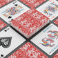 Playing cards with red and white floral design on a black surface