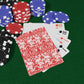 Poker chips and playing cards on a green felt surface