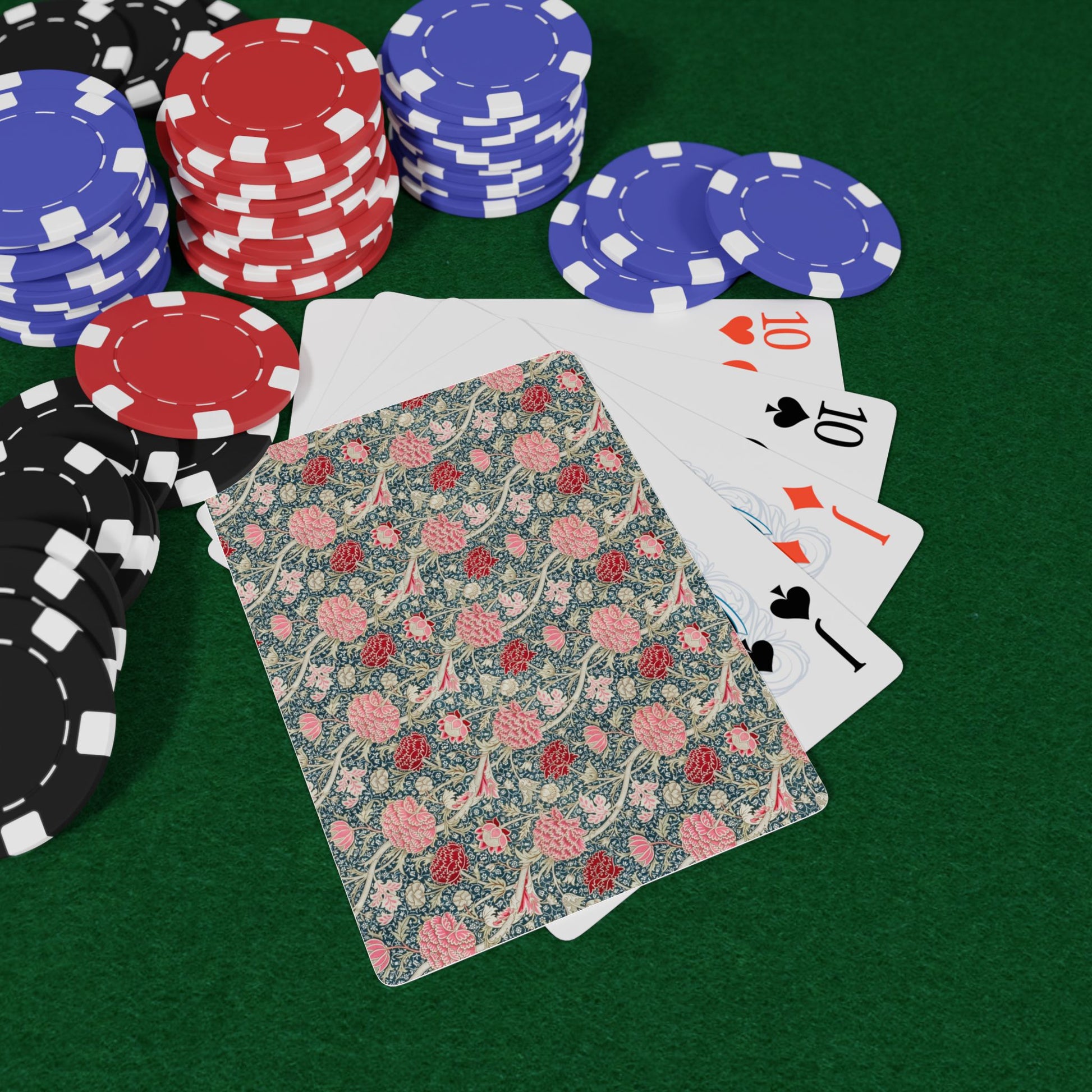 Playing cards and poker chips on a green felt surface