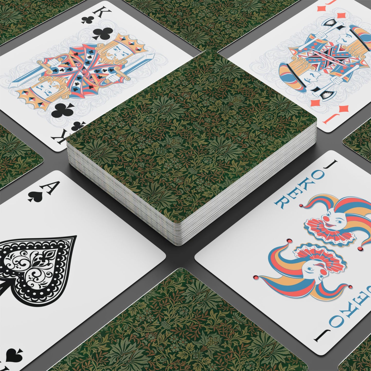 Playing cards with decorative designs on a green patterned surface