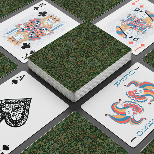 Playing cards with decorative designs on a green patterned surface