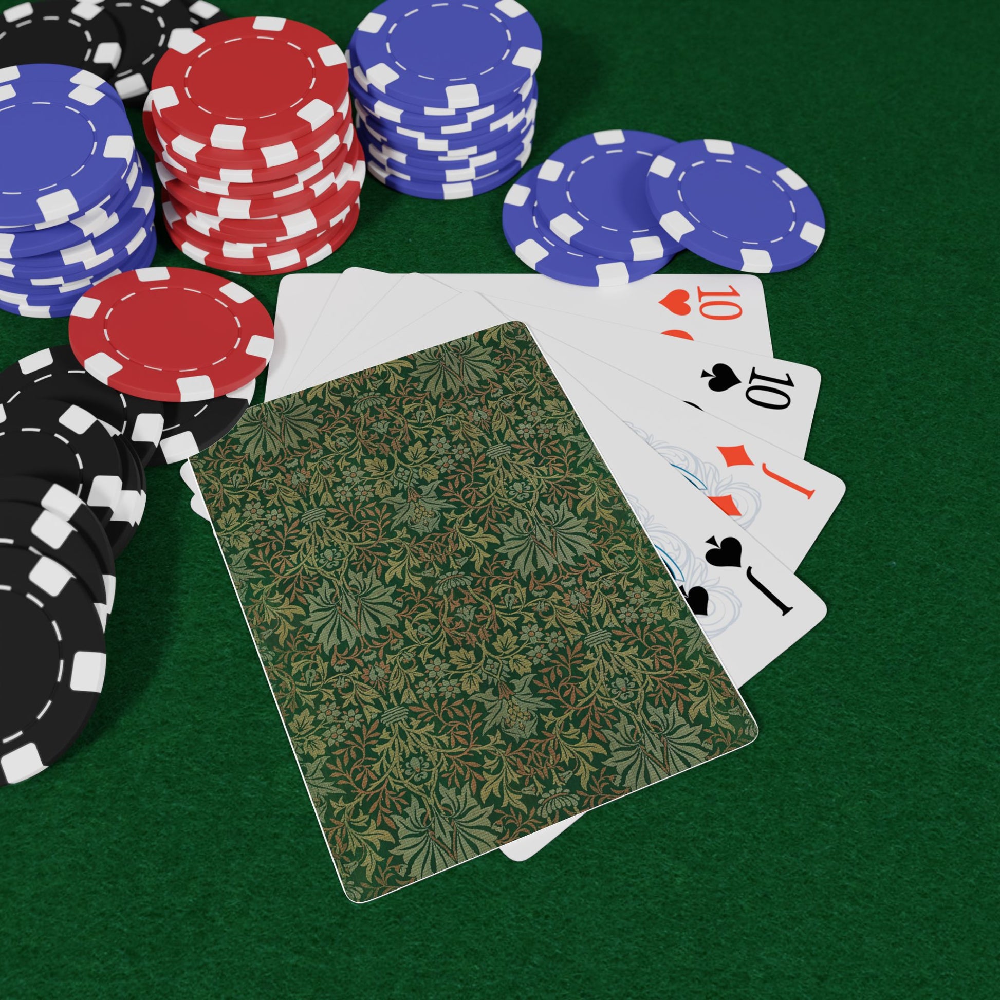 Poker chips and playing cards on a green table