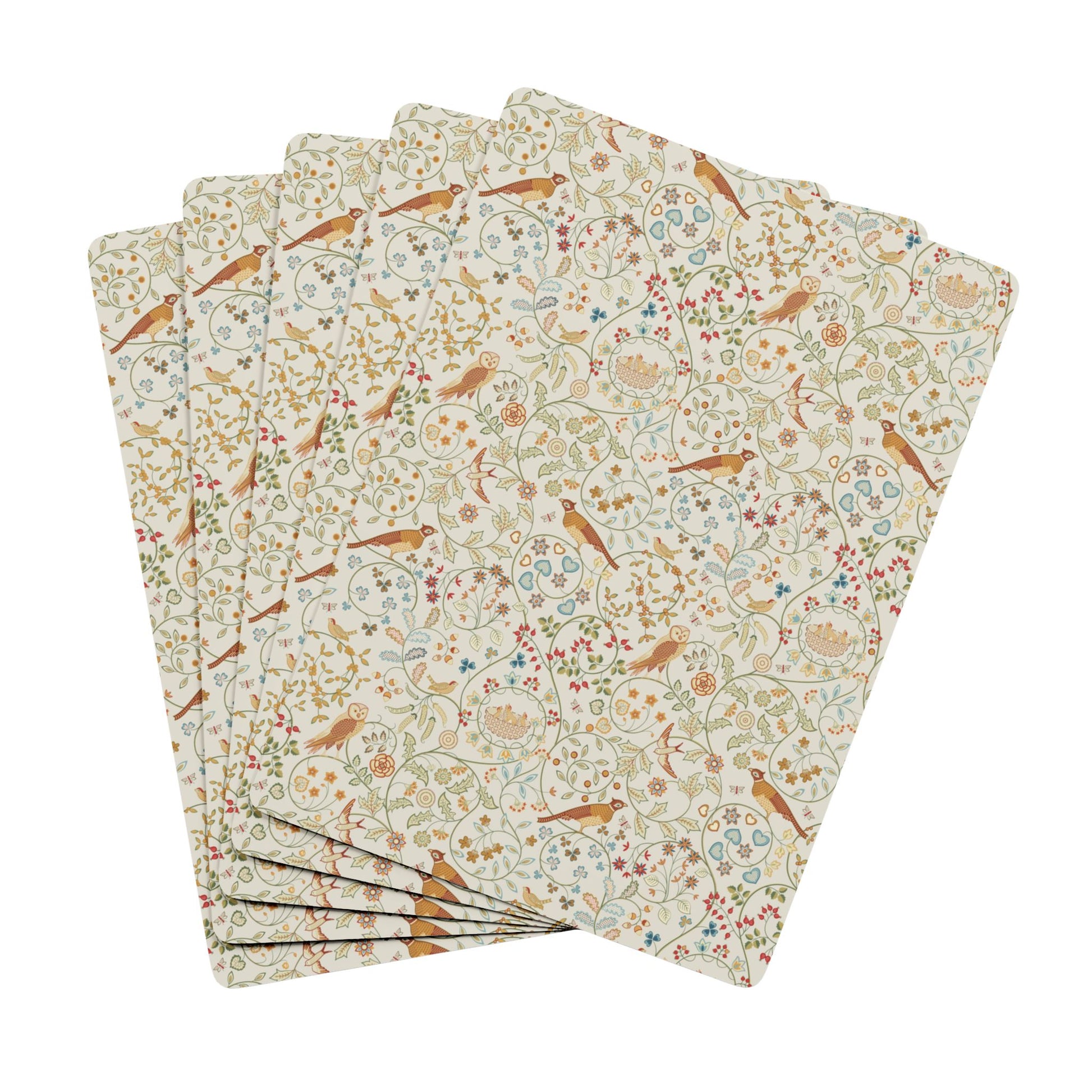Set of playing cards with floral and bird pattern on a white background