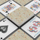 Playing cards with floral design and colorful cardinals on a checkered background