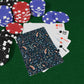 Poker chips and playing cards on a green felt surface