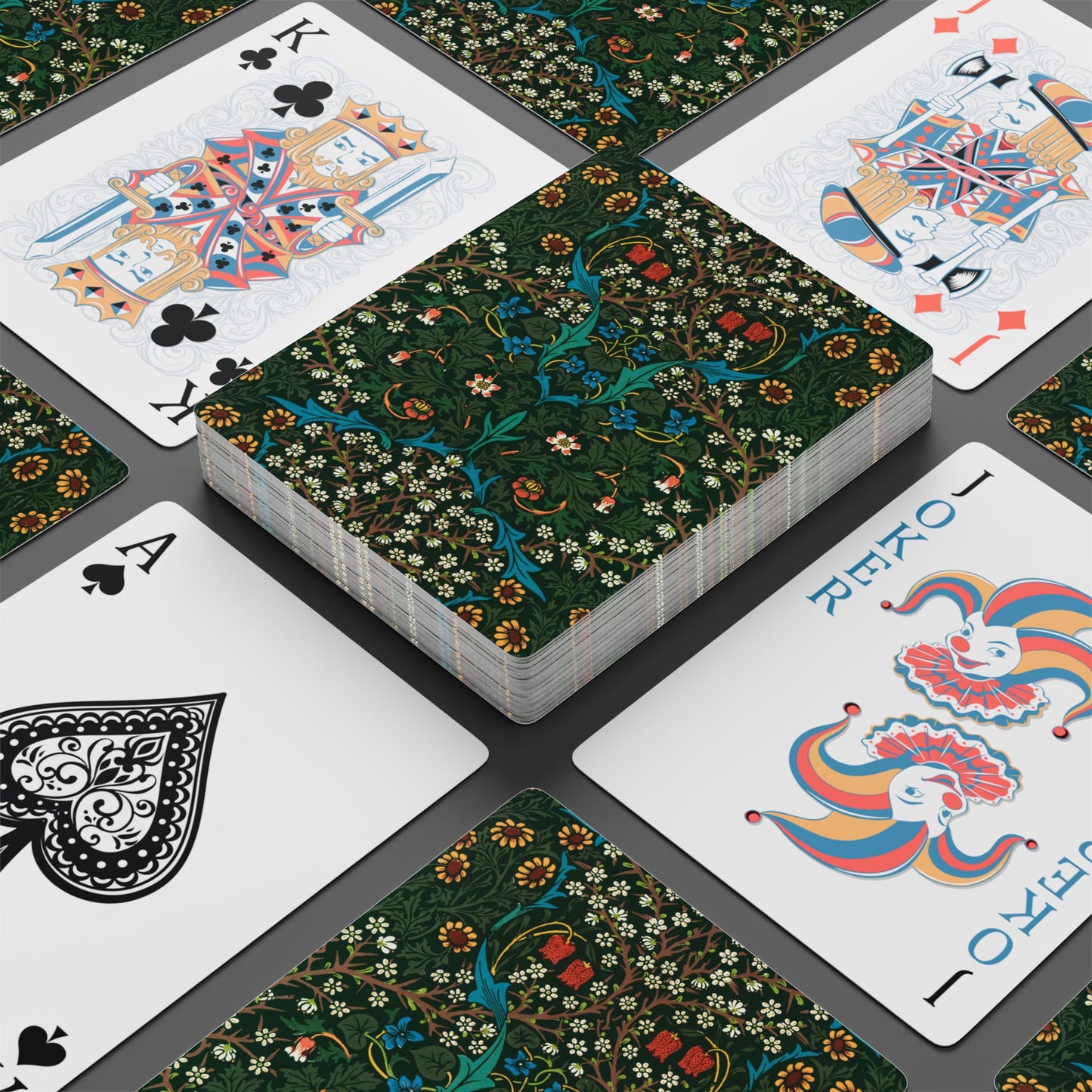 Playing cards with floral design on a gray surface