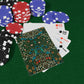 Poker chips and playing cards on a green felt surface