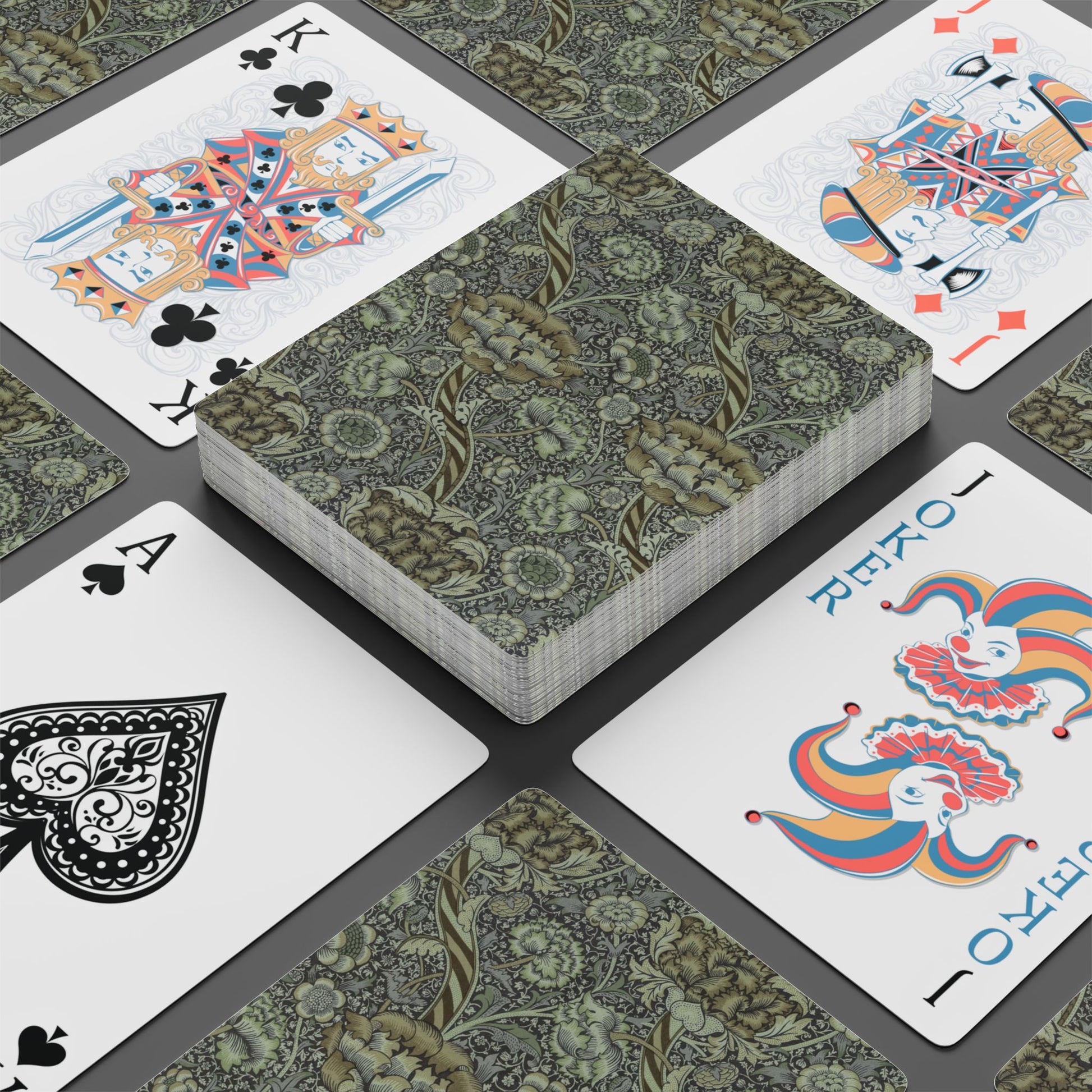 Playing cards with decorative designs on a gray surface