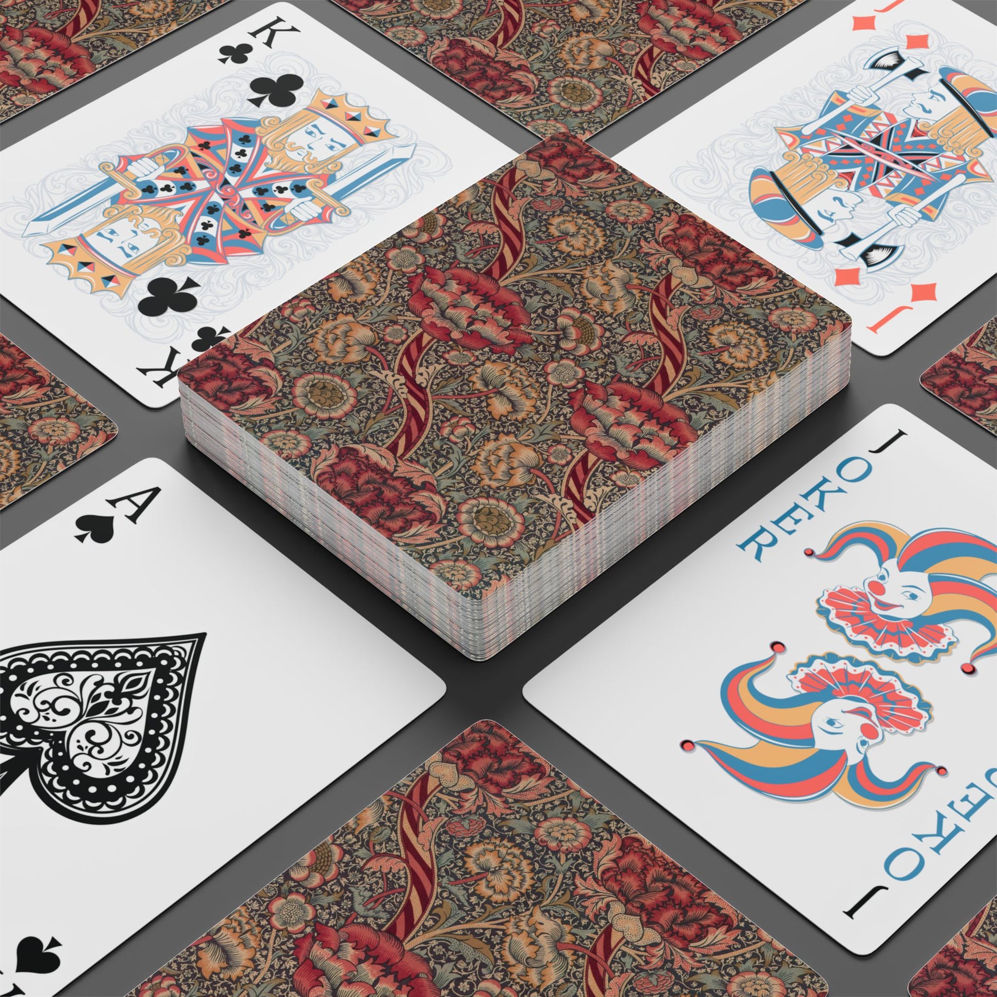 Playing cards with decorative backs on a gray surface