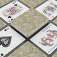 Playing cards with floral design and colorful joker card on a black surface