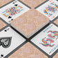 Playing cards with decorative designs on a patterned surface
