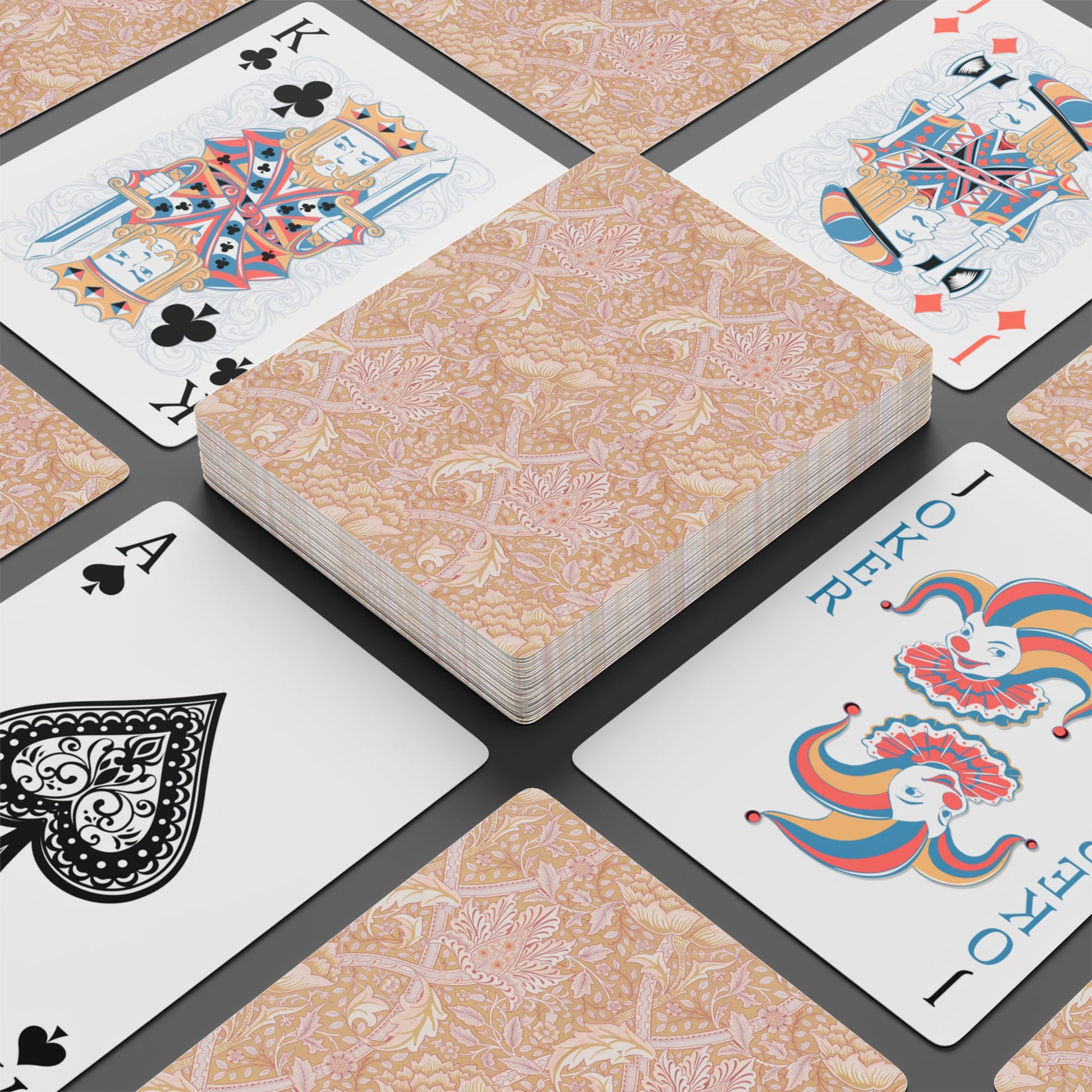 Playing cards with decorative designs on a patterned surface