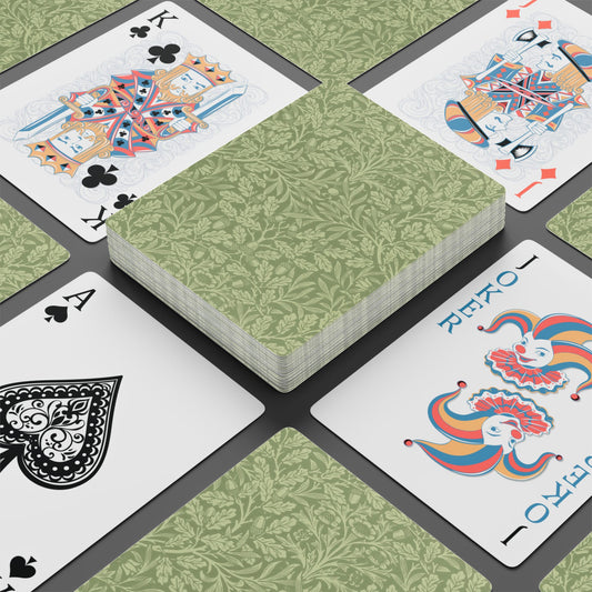 Playing cards with green patterned back and colorful front designs on a black surface