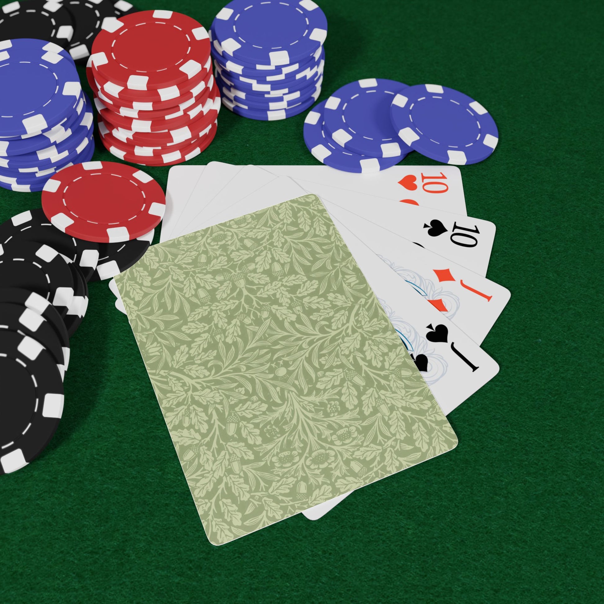 Poker chips and playing cards on a green felt surface