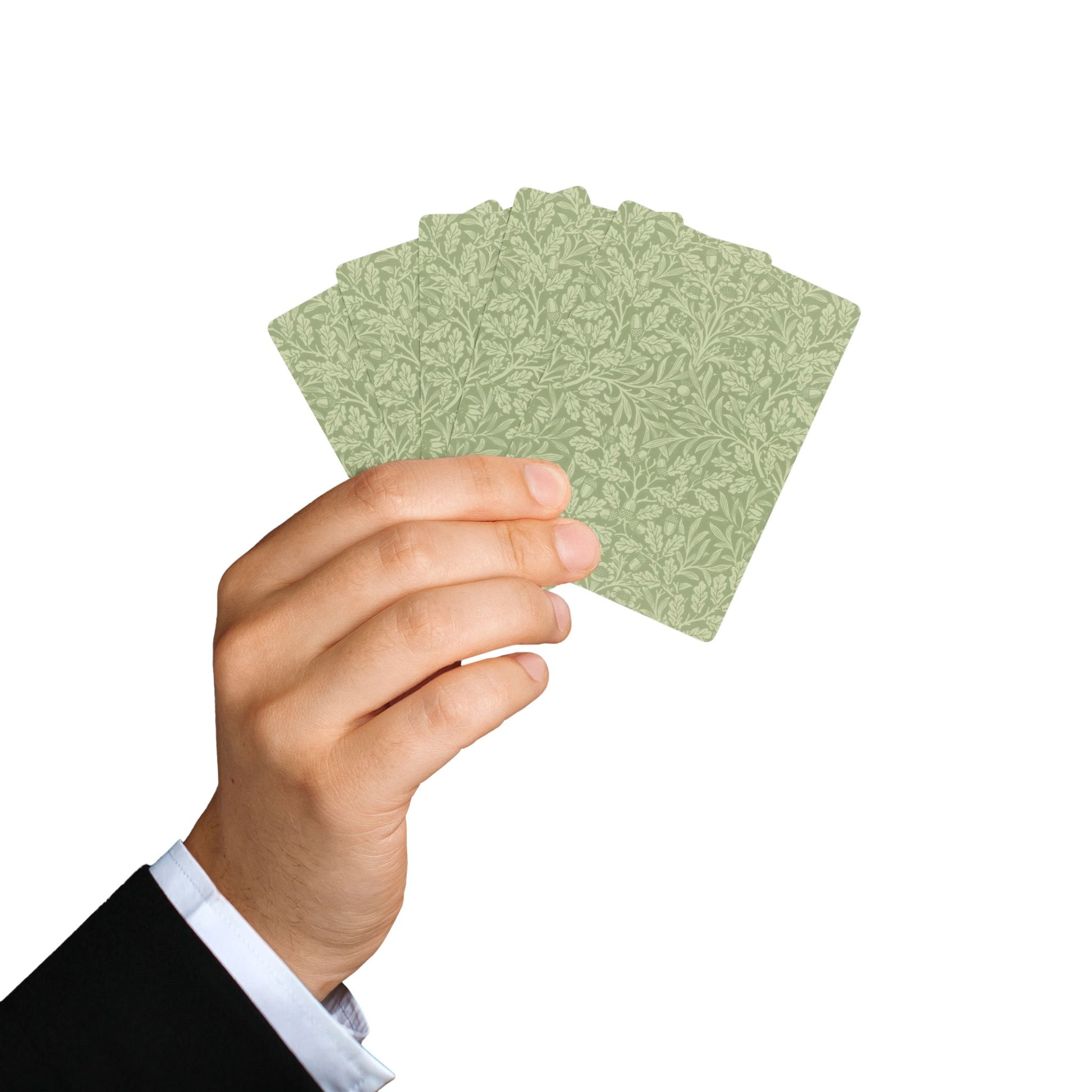 Hand holding a set of green playing cards against a white background