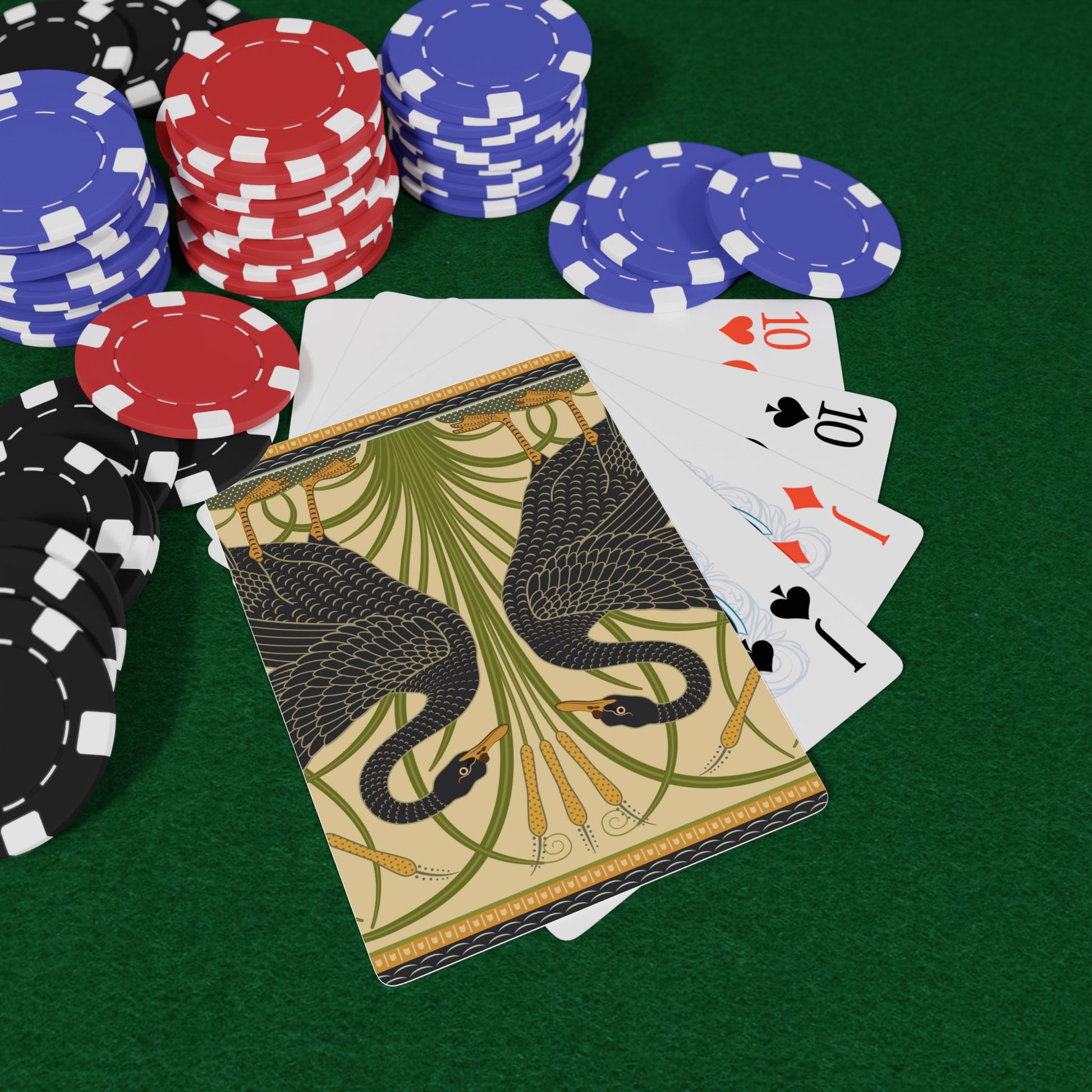 Poker chips and playing cards on a green felt surface
