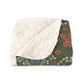 A cozy Sherpa Fleece Blanket with a geometric pattern in a mix of dark and vibrant colors, laid out flat.