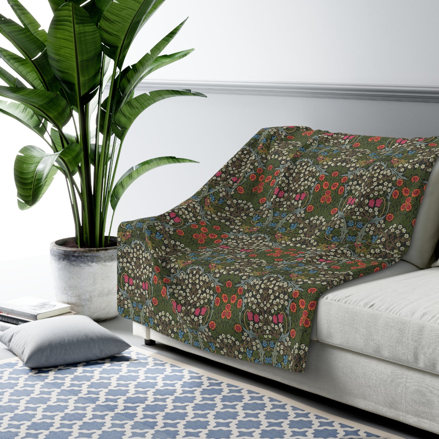 A cozy Sherpa Fleece Blanket with a geometric William Morris & Co pattern in a mix of dark and vibrant colours, laid out flat.
